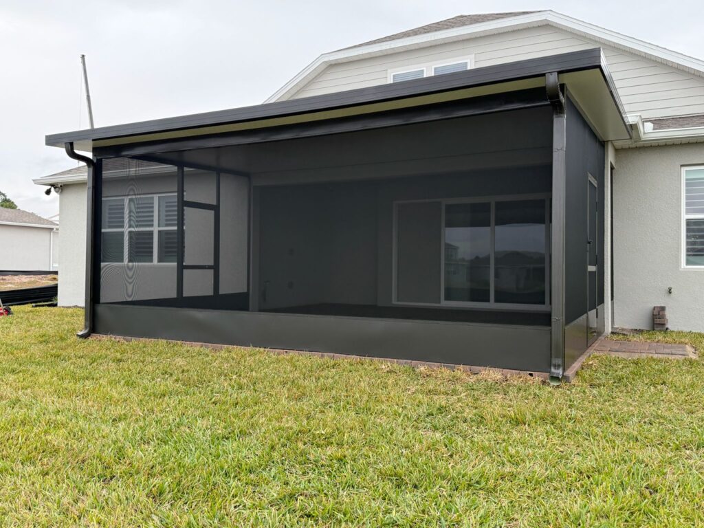 Insulated patio enclosure with solid roof panels at a residential home