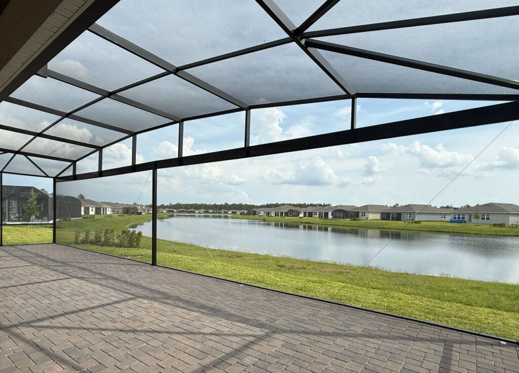 Professionally installed screen enclosure over a residential patio, designed for bug-free outdoor living in Central Florida.