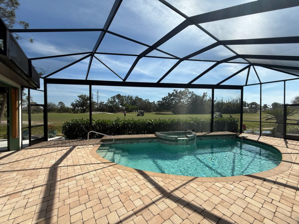 Screened pool enclosure with aluminum framing at a Florida home